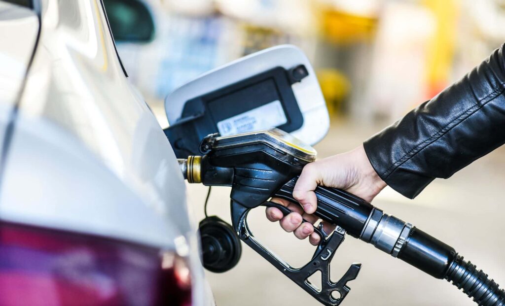 A person refuelling his car at a service station.