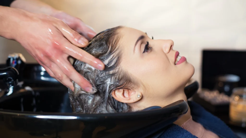 Hairdresser washing hair of the woman in modern hair salon 1280x720 1