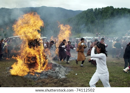 stock photo jakar bumthang bhutan september unidentified people running through an open fire at the 450w 74112502