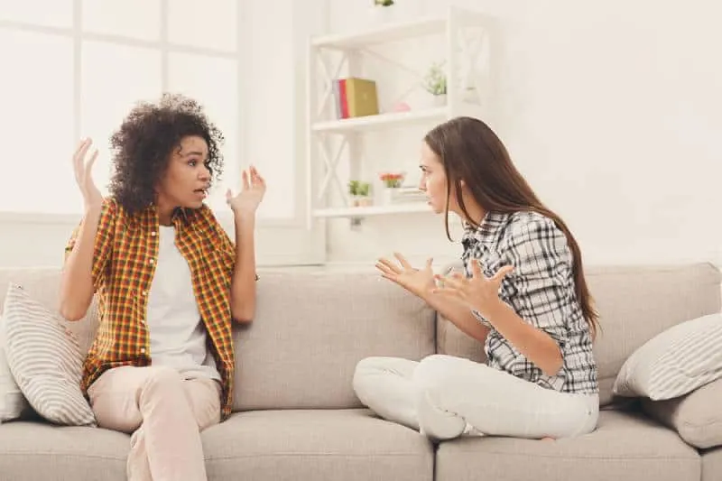 two female friends arguing at home