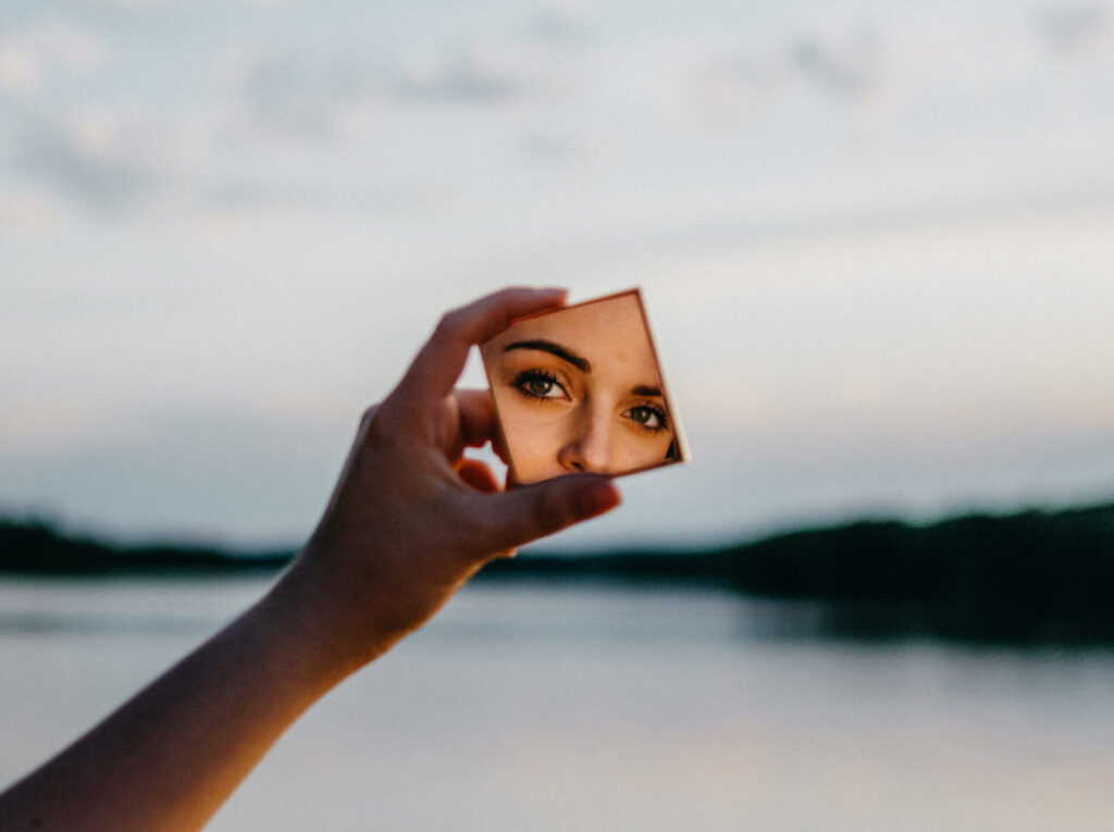 woman holding mirror 2460534 scaled e1594737341869